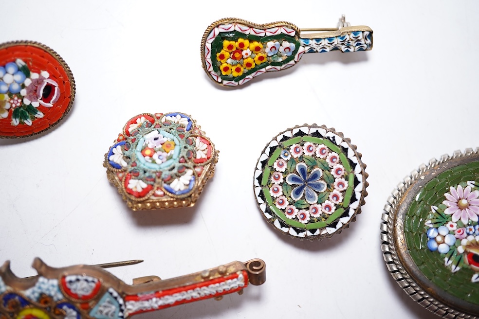 A collection of twenty-five micro-mosaic costume jewellery brooches. Including thirteen banjo and guitars shaped brooches, six large oval and circular brooches and six smaller brooches. Condition - mostly good